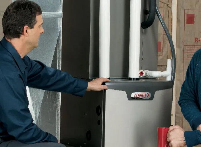 A Southside technician walking a homeowner through a newly installed Lennox furnace