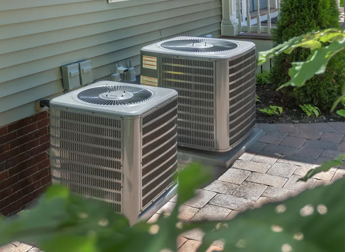 An outdoor heat pump unit serving a Twin Cities home year-round