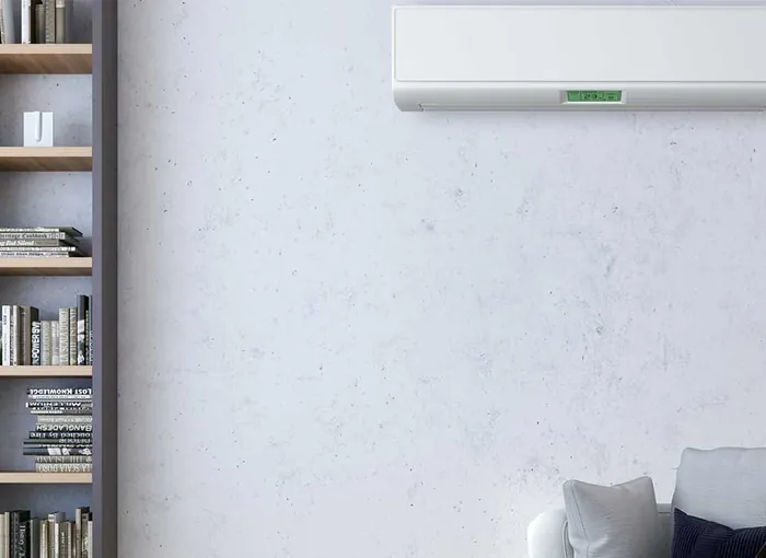 A wall-mounted ductless mini-split head heating and cooling a living room