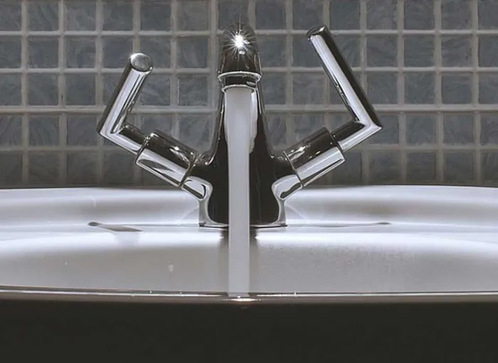 Hot water running from a tap, served by a professionally installed water heater